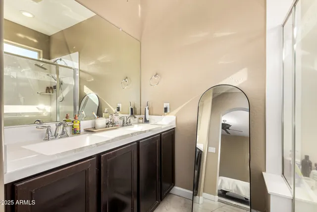 a bathroom with a double vanity sink and a mirror