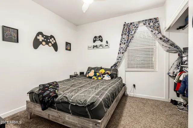 a bedroom with bed and a window