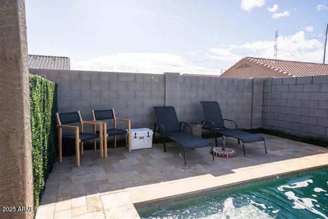 a view of a patio with table and chairs and potted plants