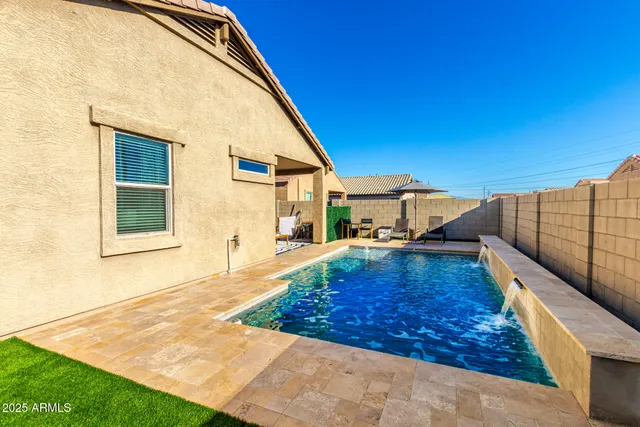 a view of a house with backyard and sitting area