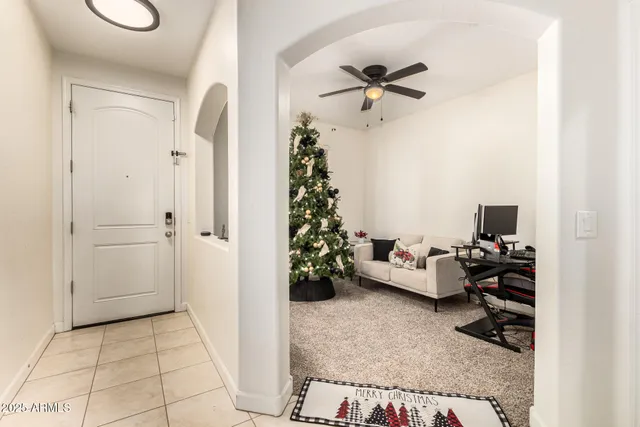 a living room with furniture and a potted plant