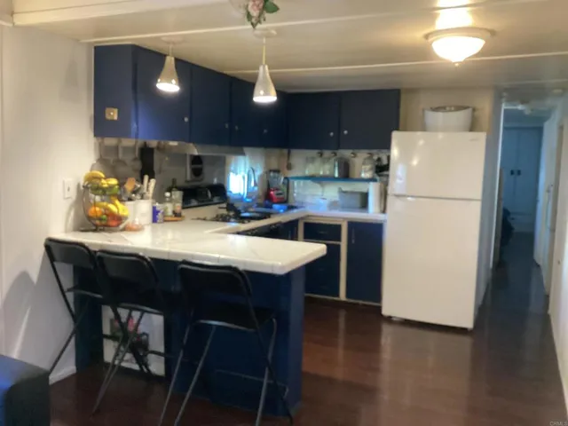 a kitchen with a sink a refrigerator and a stove