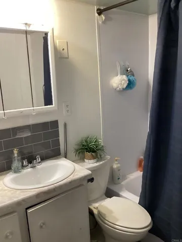 a bathroom with a sink toilet and mirror