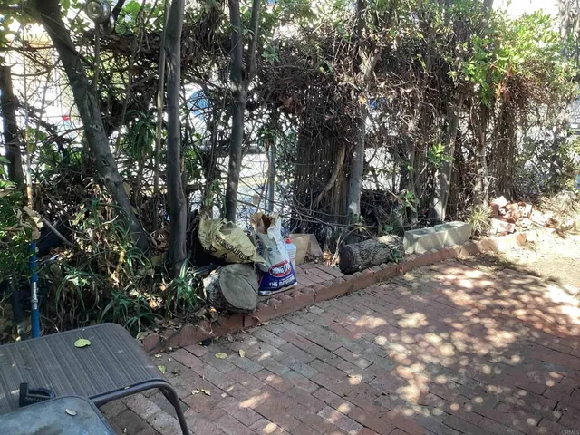a backyard of a house with table and chairs