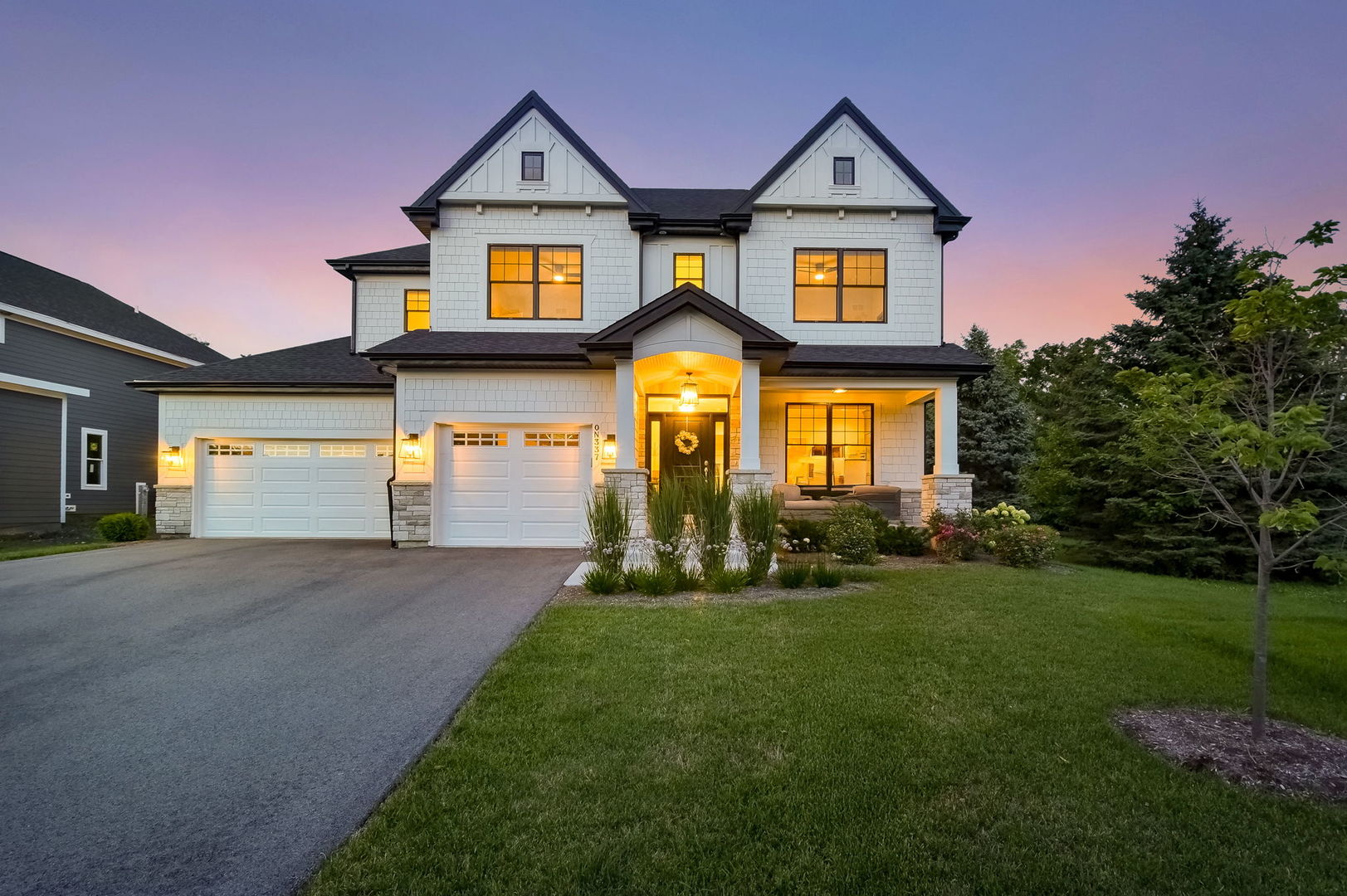 a front view of a house with a yard and garage
