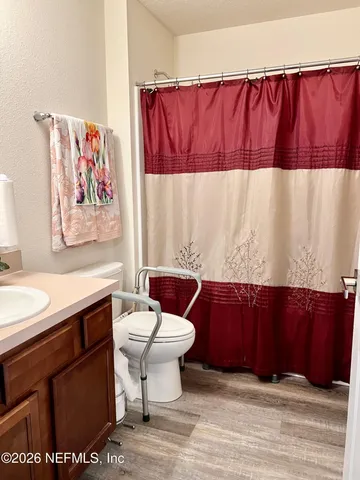 a view of a workspace with furniture and a book shelf