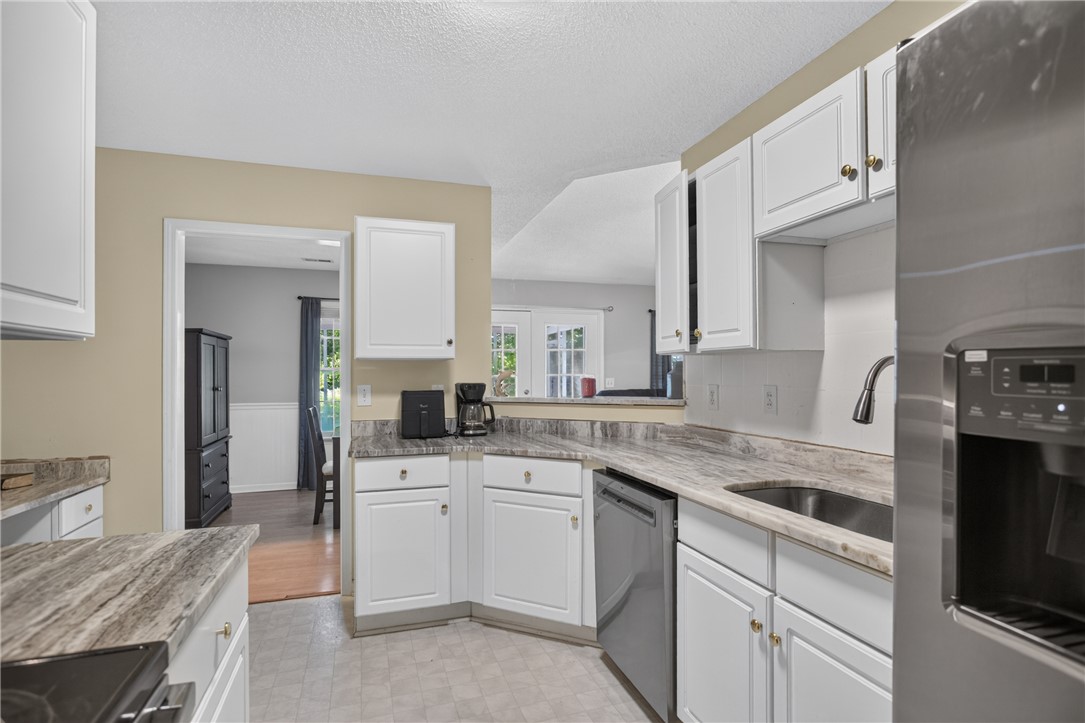 3336 Centerville Road Anderson, SC 29625 - Photo 17 of 50 A well-equipped kitchen features ample white cabinetry, sleek countertops, and stainless steel appliances.