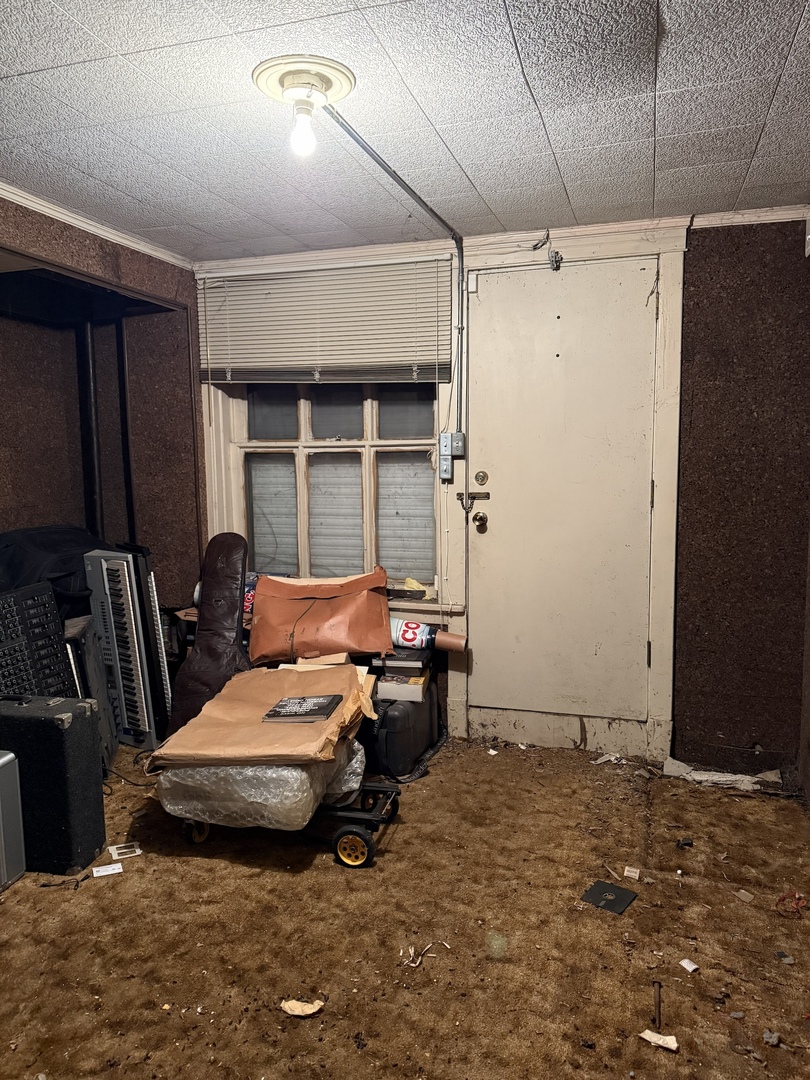 7006 South East End Avenue Chicago, IL 60649 - Photo 20 of 26 a bedroom with a bed and large windows