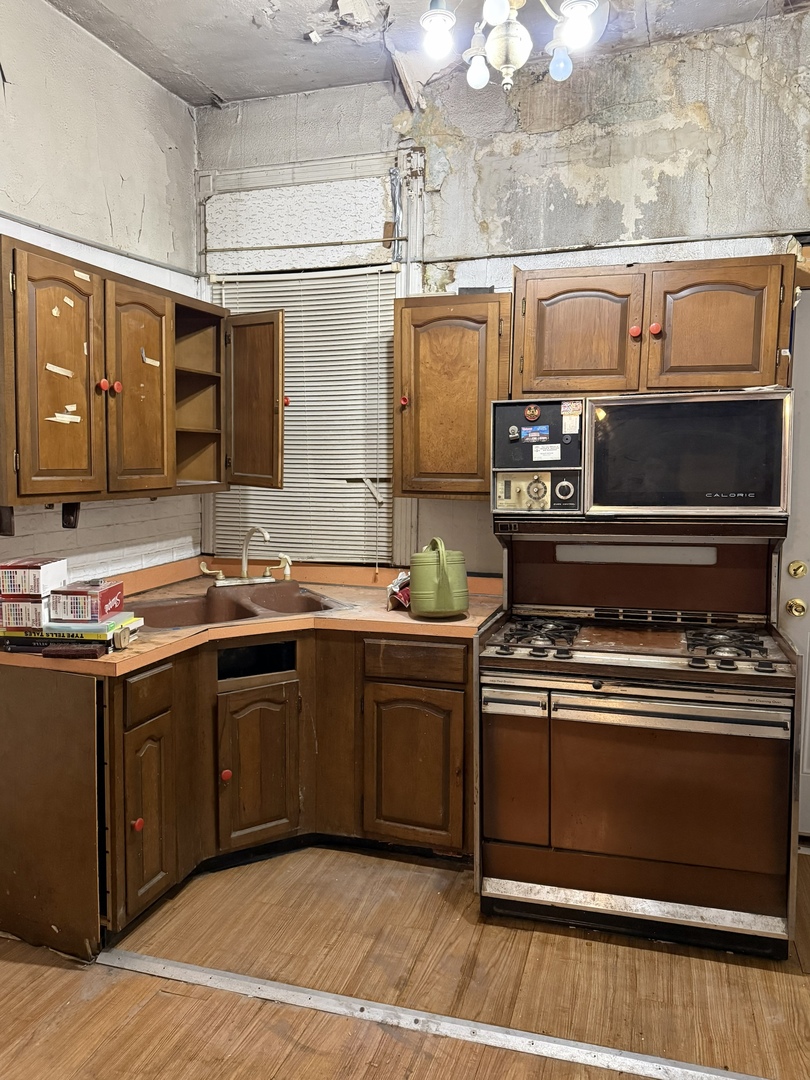 7006 South East End Avenue Chicago, IL 60649 - Photo 7 of 26 a kitchen with stainless steel appliances granite countertop a stove and a sink