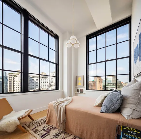 a view of a workspace with furniture and window