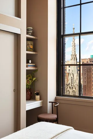 a room with a window and furniture