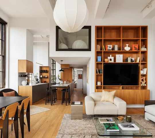 a living room with furniture and floor to ceiling windows