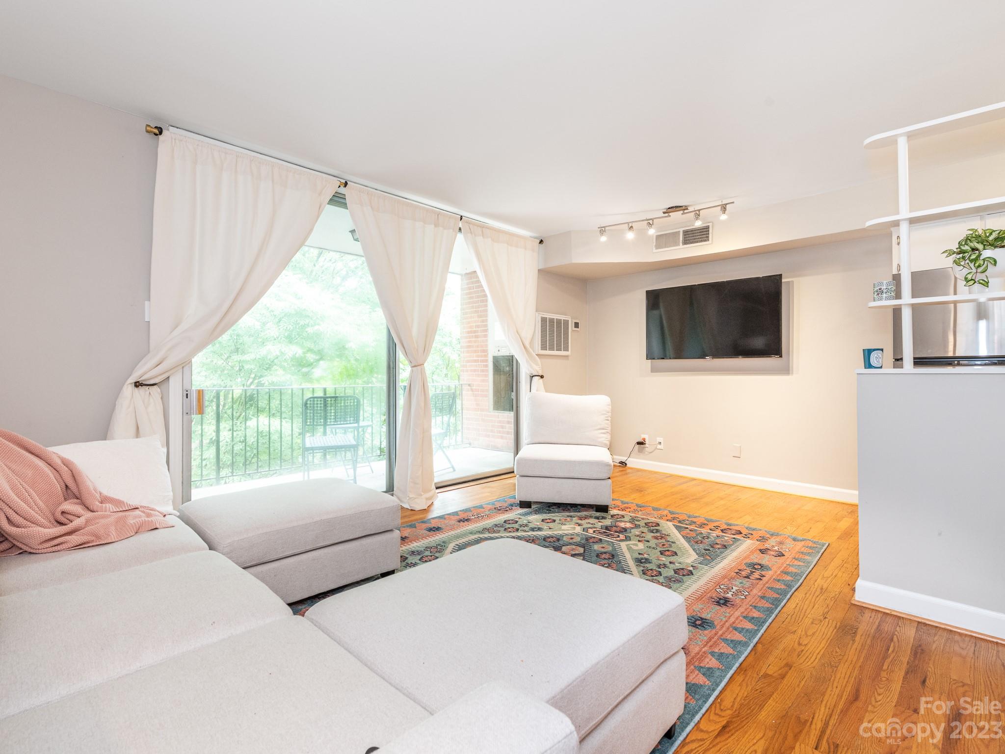 400 Queens Road, Unit C6 Charlotte, NC 28207 - Photo 11 of 25 a living room with furniture and a flat screen tv