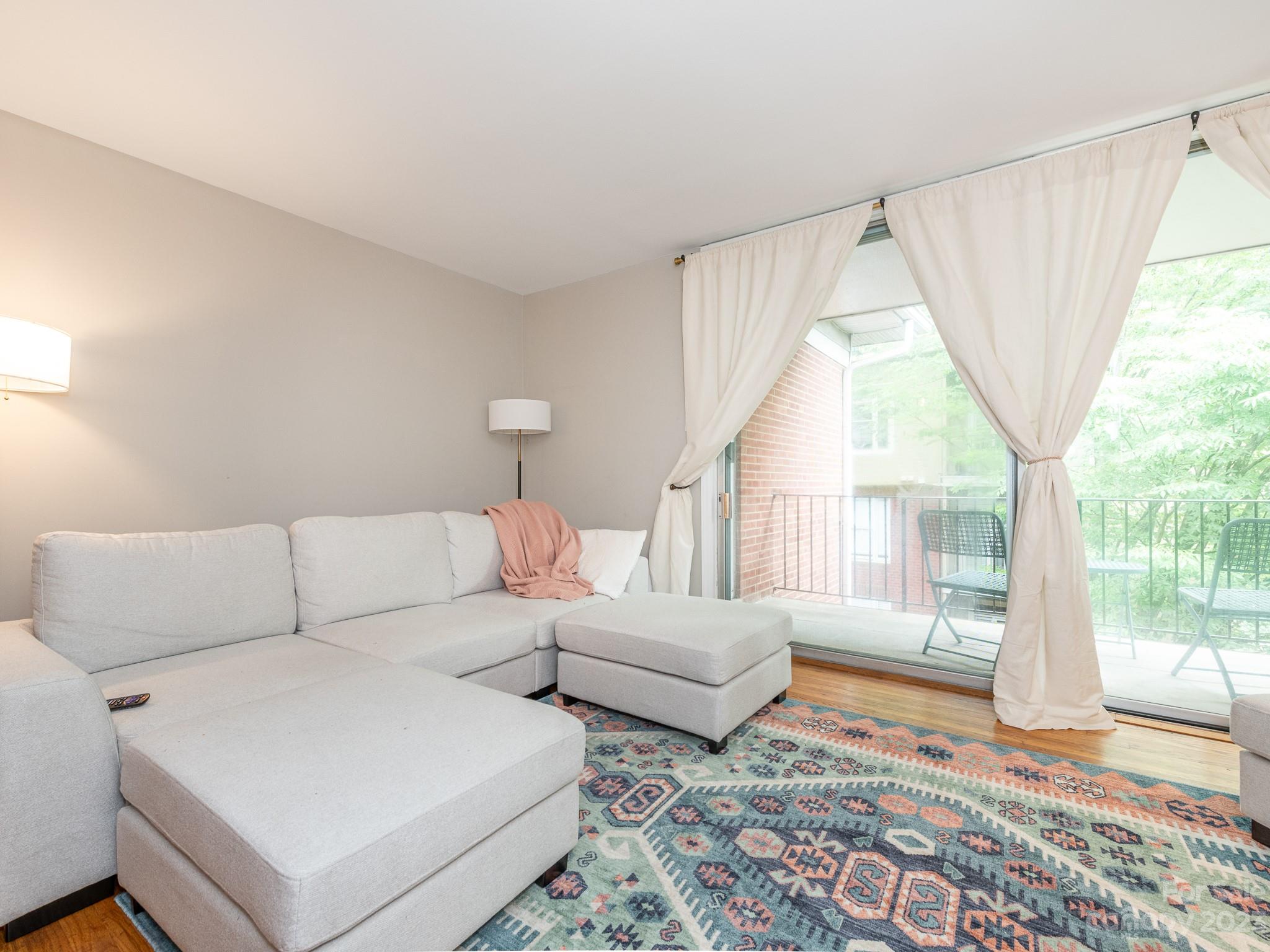 400 Queens Road, Unit C6 Charlotte, NC 28207 - Photo 12 of 25 a living room with furniture and a window