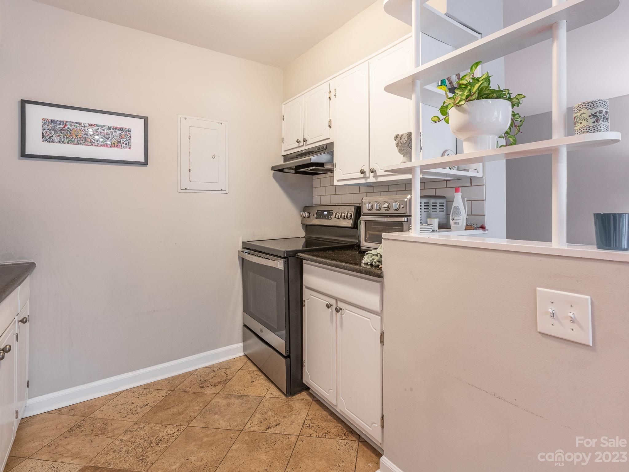 400 Queens Road, Unit C6 Charlotte, NC 28207 - Photo 14 of 25 a kitchen with stainless steel appliances cabinets and window