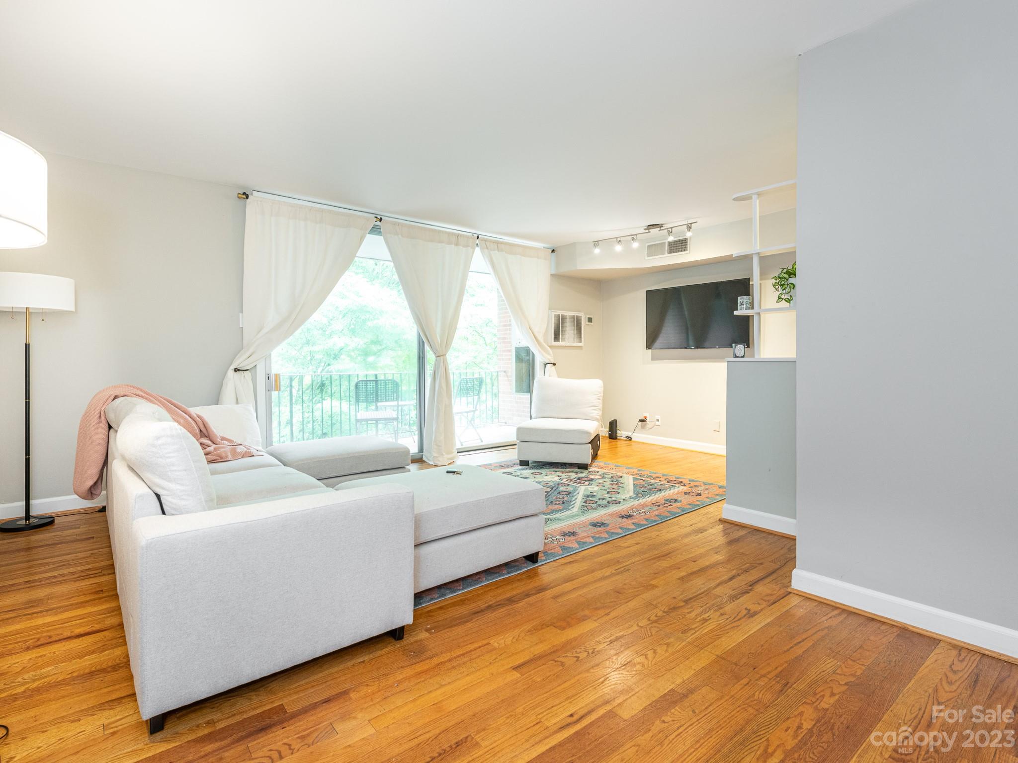 400 Queens Road, Unit C6 Charlotte, NC 28207 - Photo 3 of 25 a living room with furniture and a large window