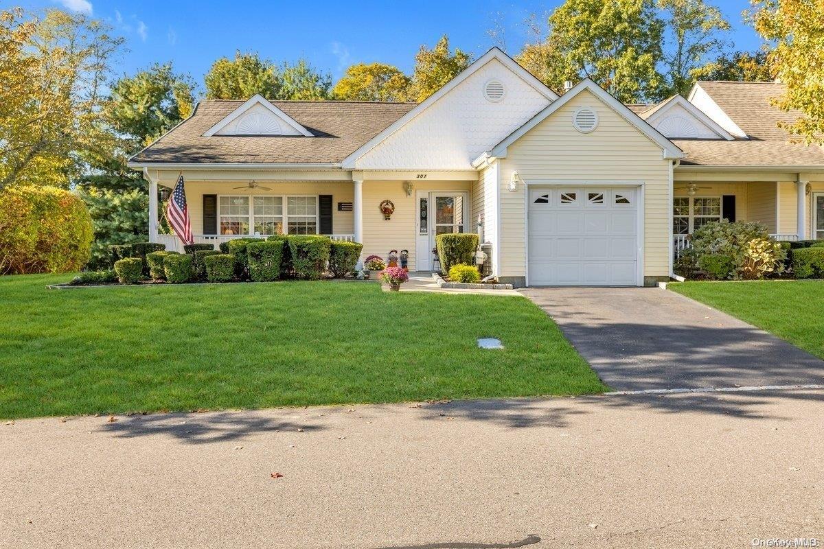 a front view of a house with a yard and garage