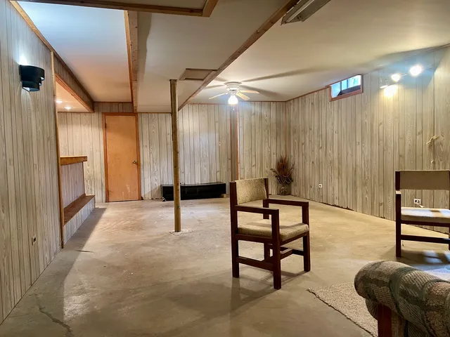 a view of a livingroom with furniture and a window