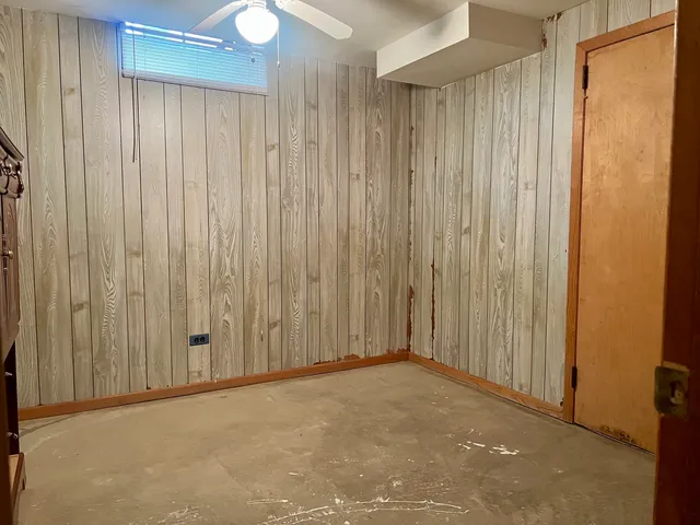 an empty room with a wooden door