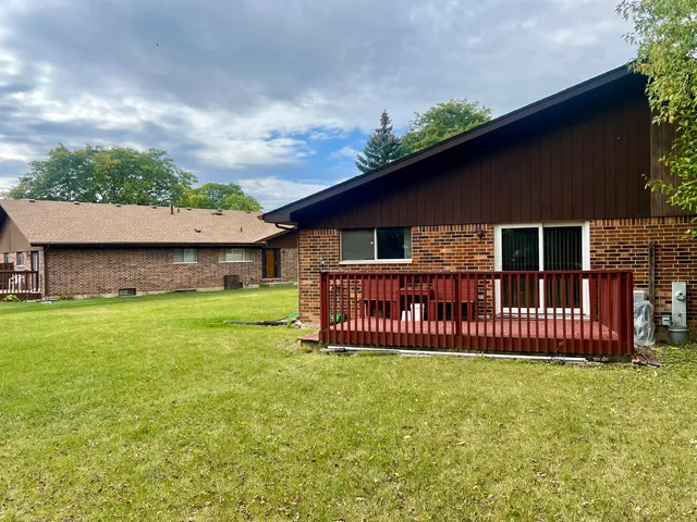 a view of a house with a yard and deck