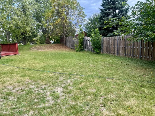 a backyard of a house with lots of green space
