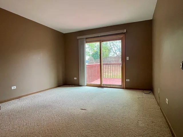 a view of empty room with floor to ceiling window