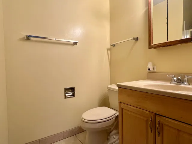 a bathroom with a sink a toilet and a mirror