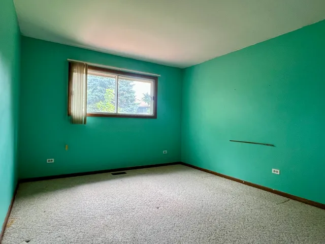 an empty room with a window and a projector