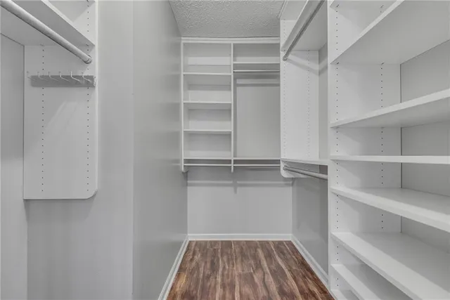 a view of walk in closet with empty racks