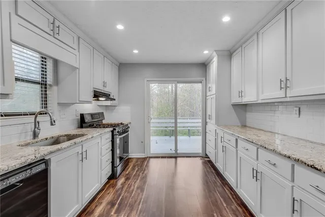 a kitchen with a sink stove and cabinets