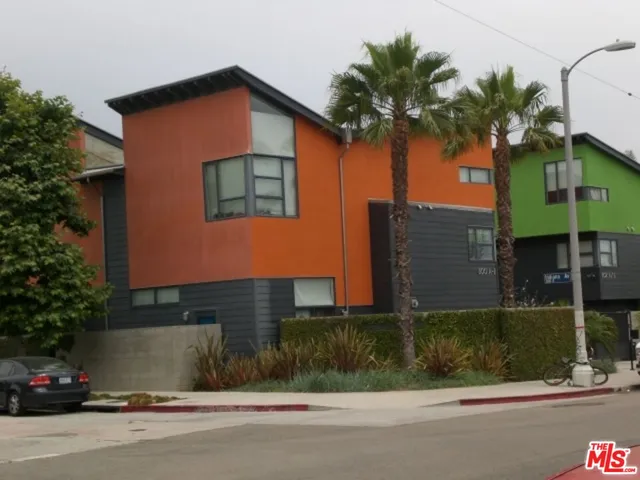 a front view of a house with a garden and yard