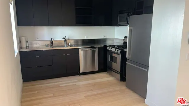 a view of empty room with wooden floor and stairs