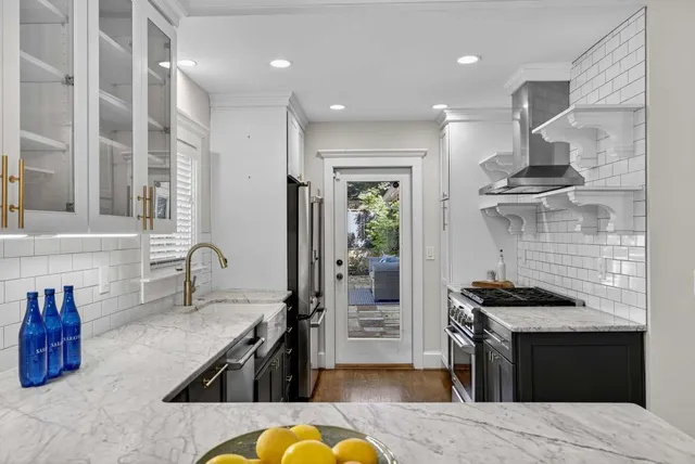 a kitchen with stainless steel appliances granite countertop a stove and a refrigerator