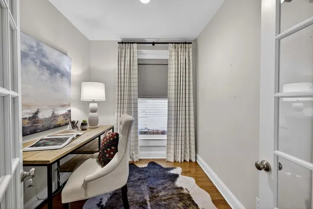 a bedroom with a bed and a large window