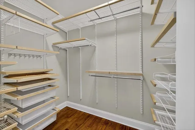 a bathroom with a granite countertop toilet a sink and a mirror