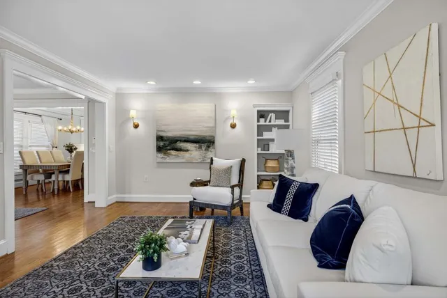 a large kitchen with sink a refrigerator and chairs