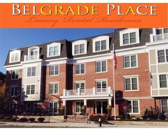 a front view of a building with a street sign