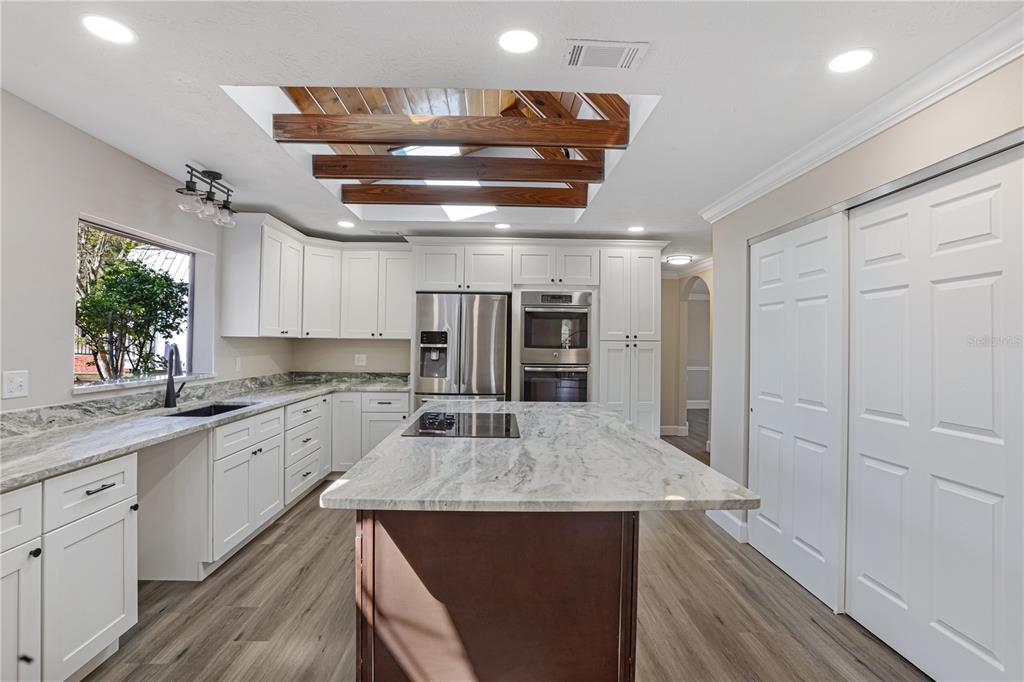 2830 Southeast 31st Street Ocala, FL 34471 - Photo 18 of 23 a kitchen with stainless steel appliances a sink and a refrigerator