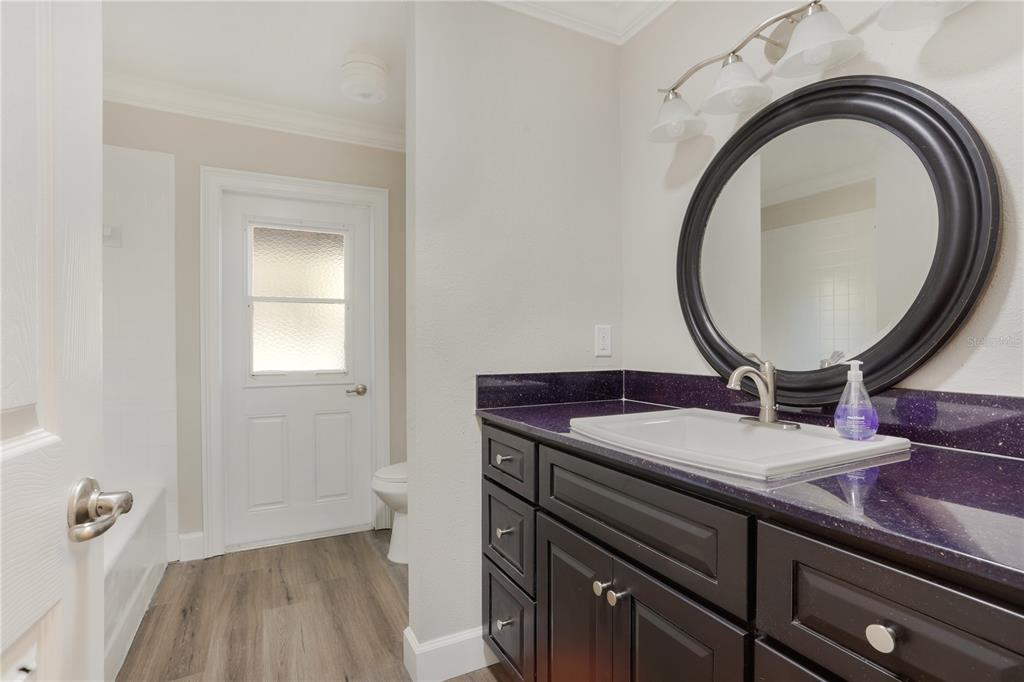 2830 Southeast 31st Street Ocala, FL 34471 - Photo 20 of 23 a bathroom with a granite countertop sink a toilet and a mirror