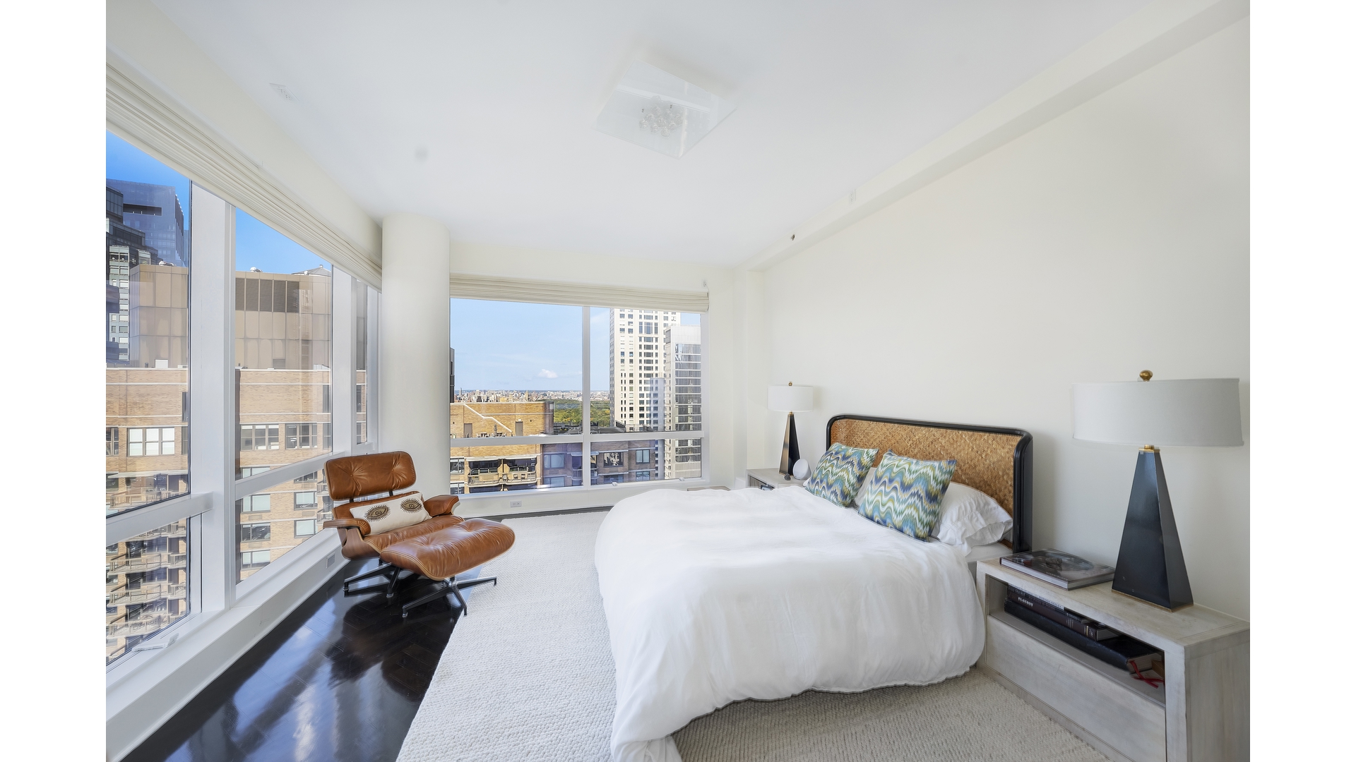 230 West 56th Street, Unit 54F Manhattan, NY 10019 - Photo 7 of 12 a bed room with a bed and a couch