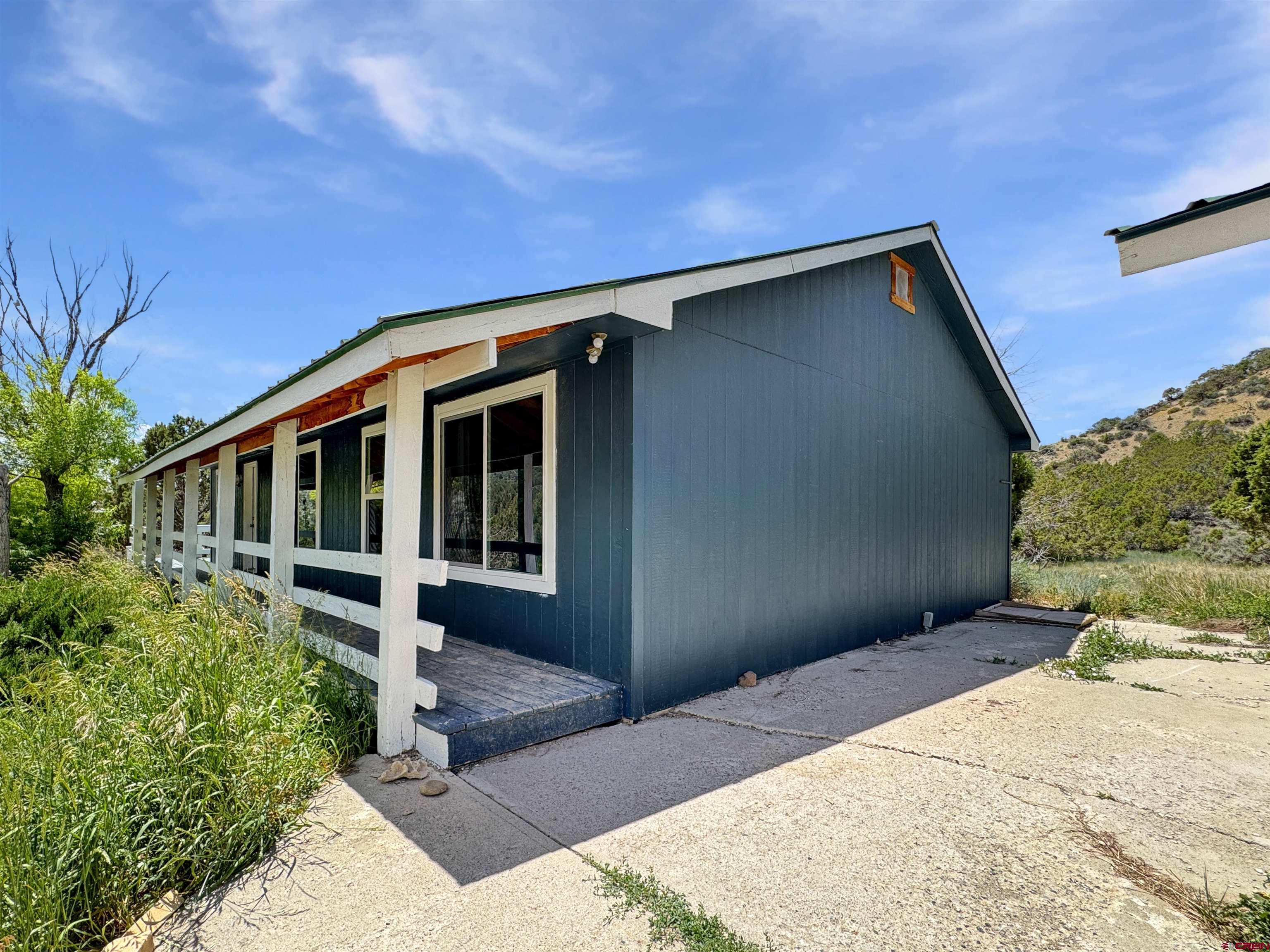43157 Long Gulch Road Crawford, CO 81415 - Photo 13 of 35 a front view of a house with a yard