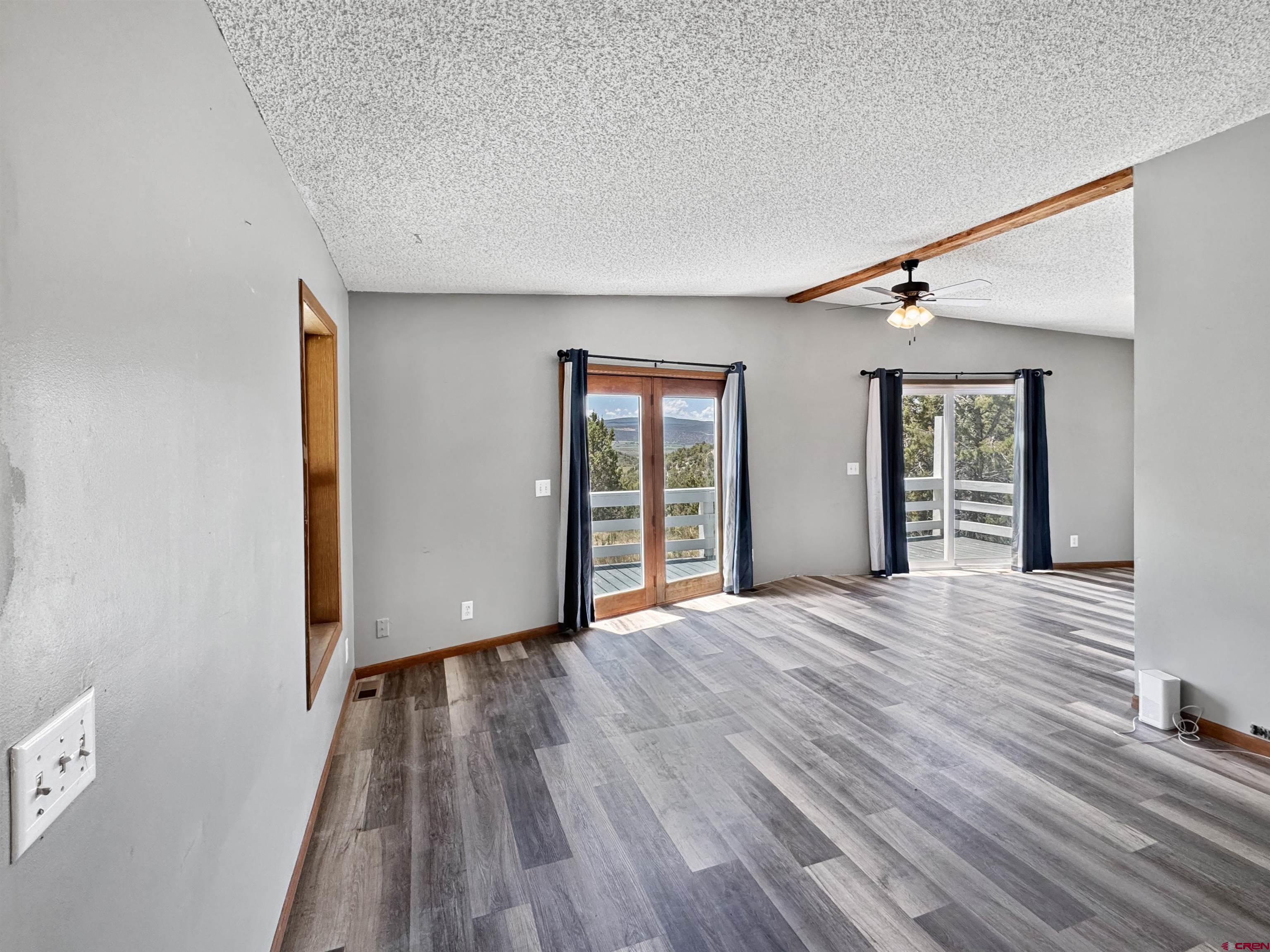 43157 Long Gulch Road Crawford, CO 81415 - Photo 15 of 35 a view of an empty room with wooden floor and a window