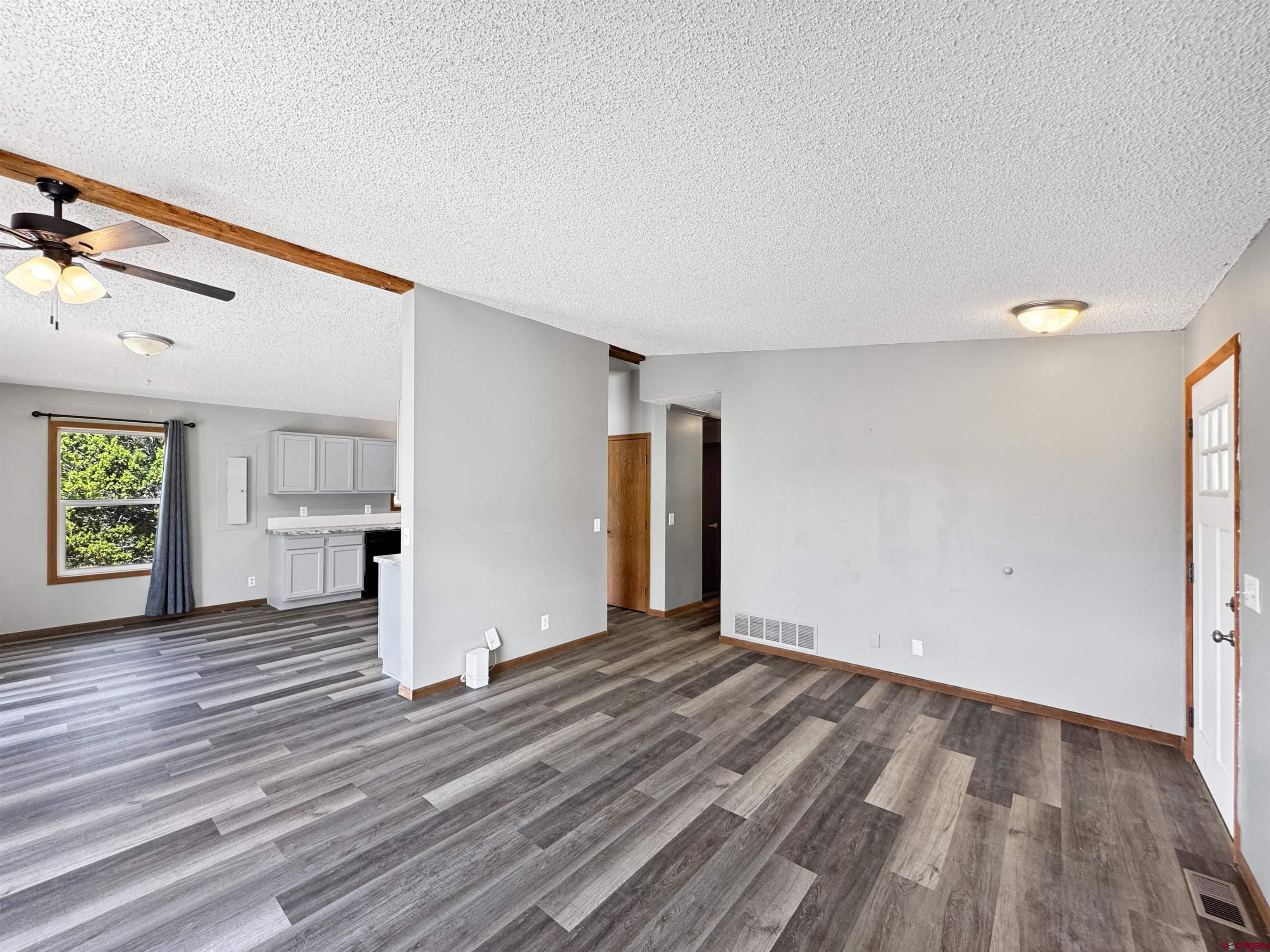 43157 Long Gulch Road Crawford, CO 81415 - Photo 16 of 35 a view of empty room with wooden floor and fan