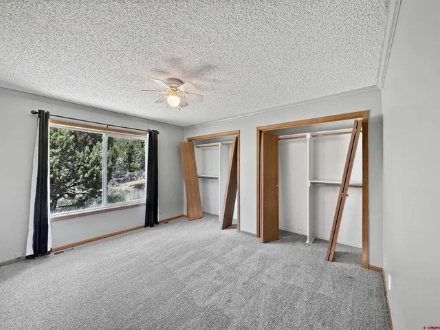 an empty room with windows and closet
