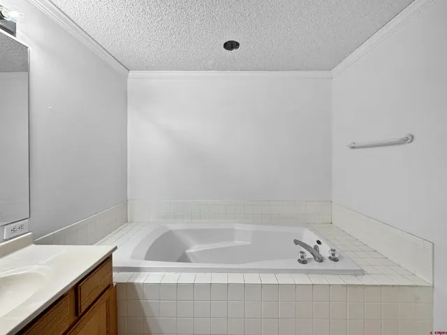 a bath tub sitting next to a white sink