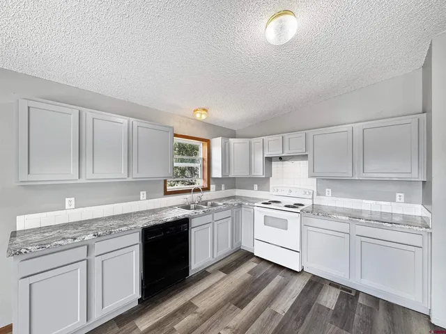 a kitchen with a sink stove and cabinets