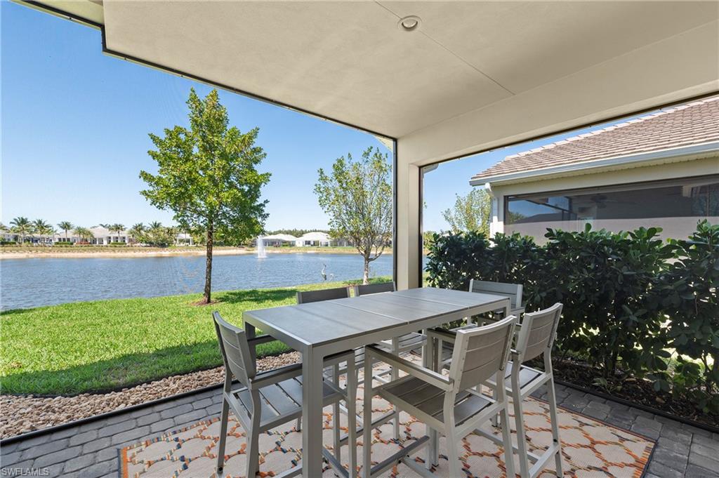 8897 Redonda Drive Naples, FL 34114 - Photo 17 of 42 a patio with table and chairs