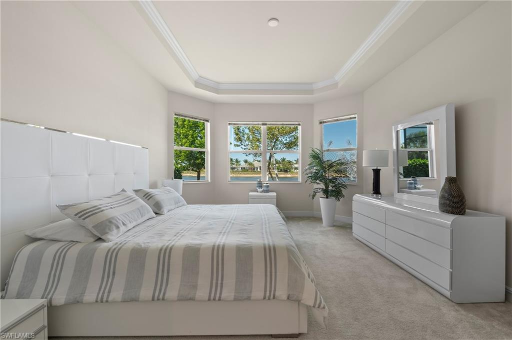 8897 Redonda Drive Naples, FL 34114 - Photo 19 of 42 a spacious bedroom with a large bed and a couch