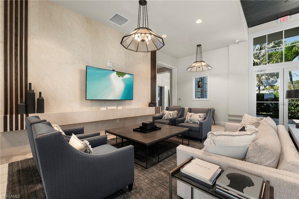 8897 Redonda Drive Naples, FL 34114 - Photo 34 of 42 a living room with furniture and a chandelier