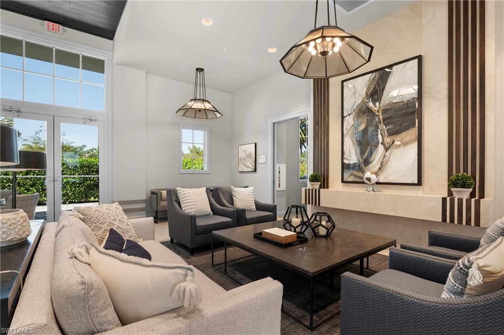 8897 Redonda Drive Naples, FL 34114 - Photo 35 of 42 a living room with furniture a chandelier and a window